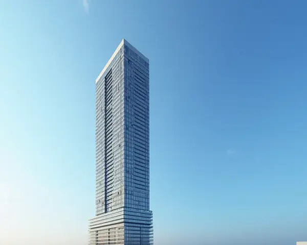 Nowoczesny wieżowiec z przeszkloną fasadą na tle błękitnego nieba. Trudno jednoznacznie określić, ile pięter ma ten skytower, ale z pewnością jest ich wiele.
