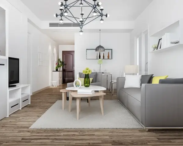 Nowe przepisy Airbnb: dlaczego od 20 maja 2026 r. każdy lokal musi mieć numer rejestracyjny? Nowoczesny salon z szarą kanapą i stolikami kawowymi.