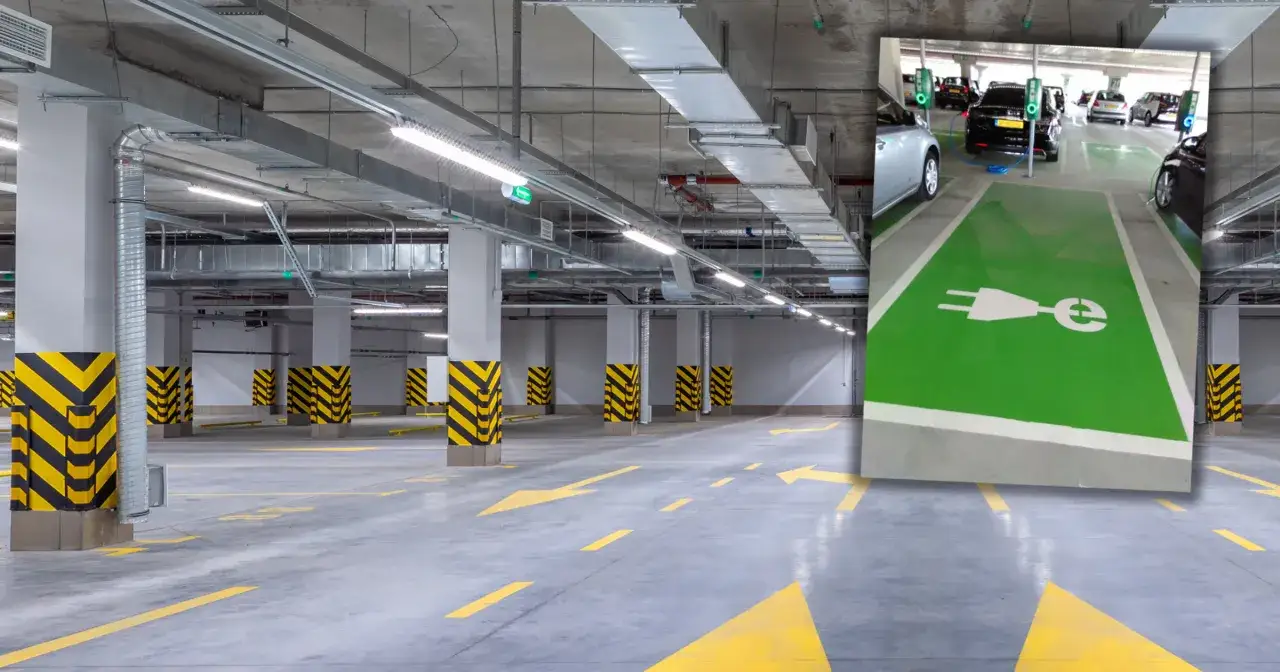 Czy parkingi podziemne w blokach są bezpieczne dla samochodów elektrycznych w 2026? Widok na nowoczesny parking podziemny z miejscami do ładowania pojazdów elektrycznych.